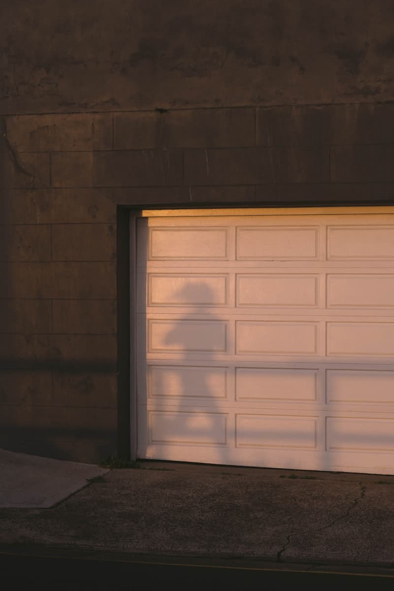 Close-up of a white raised-panel sectional garage door