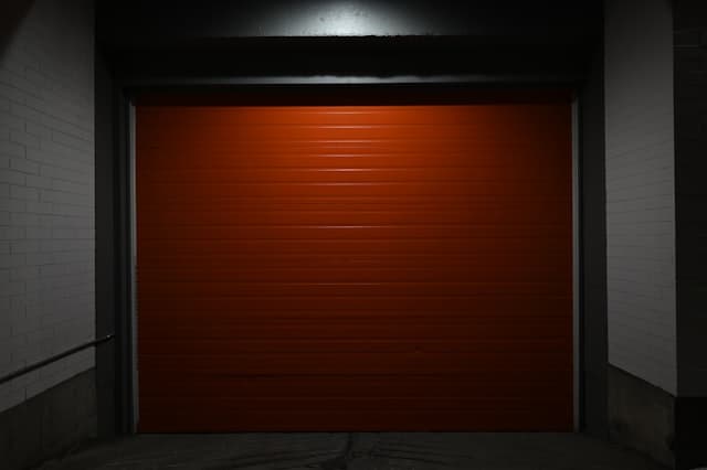 Garage door lit at night during an after-hours emergency repair call