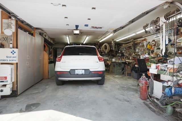 Ceiling-mounted belt-drive garage door opener in a residential garage