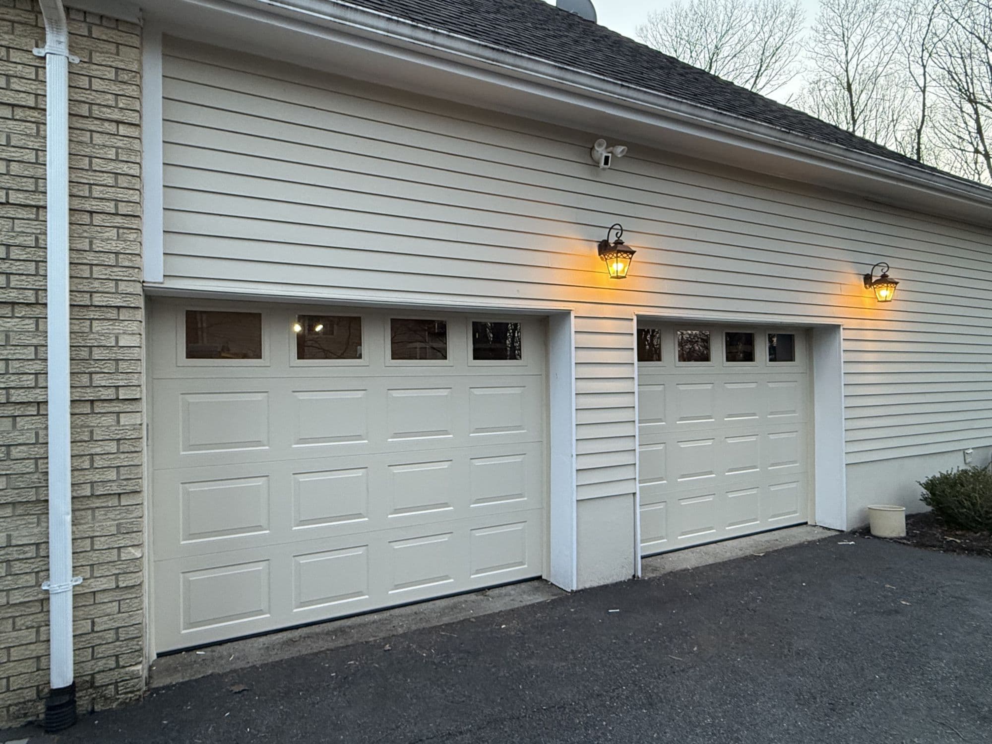 The same garage after Garage Door USA installed two new steel overhead doors with window inserts