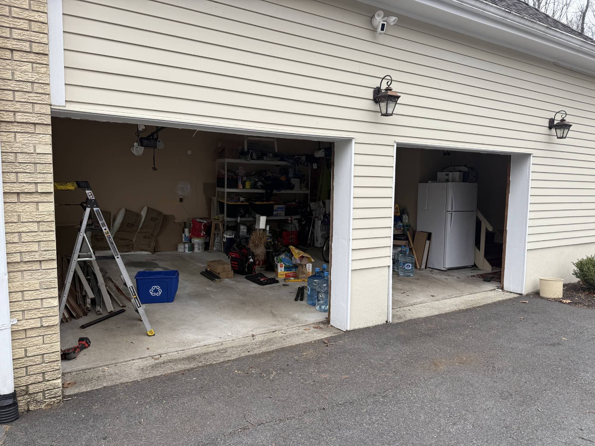 Garage with both aging doors removed before replacement, openings exposed